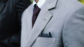 Man wearing gray suit with white shirt