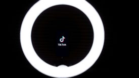 Tiktok logo inside ring light on black background