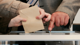 Three people fighting for envelope