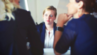 Three women in a serious meeting